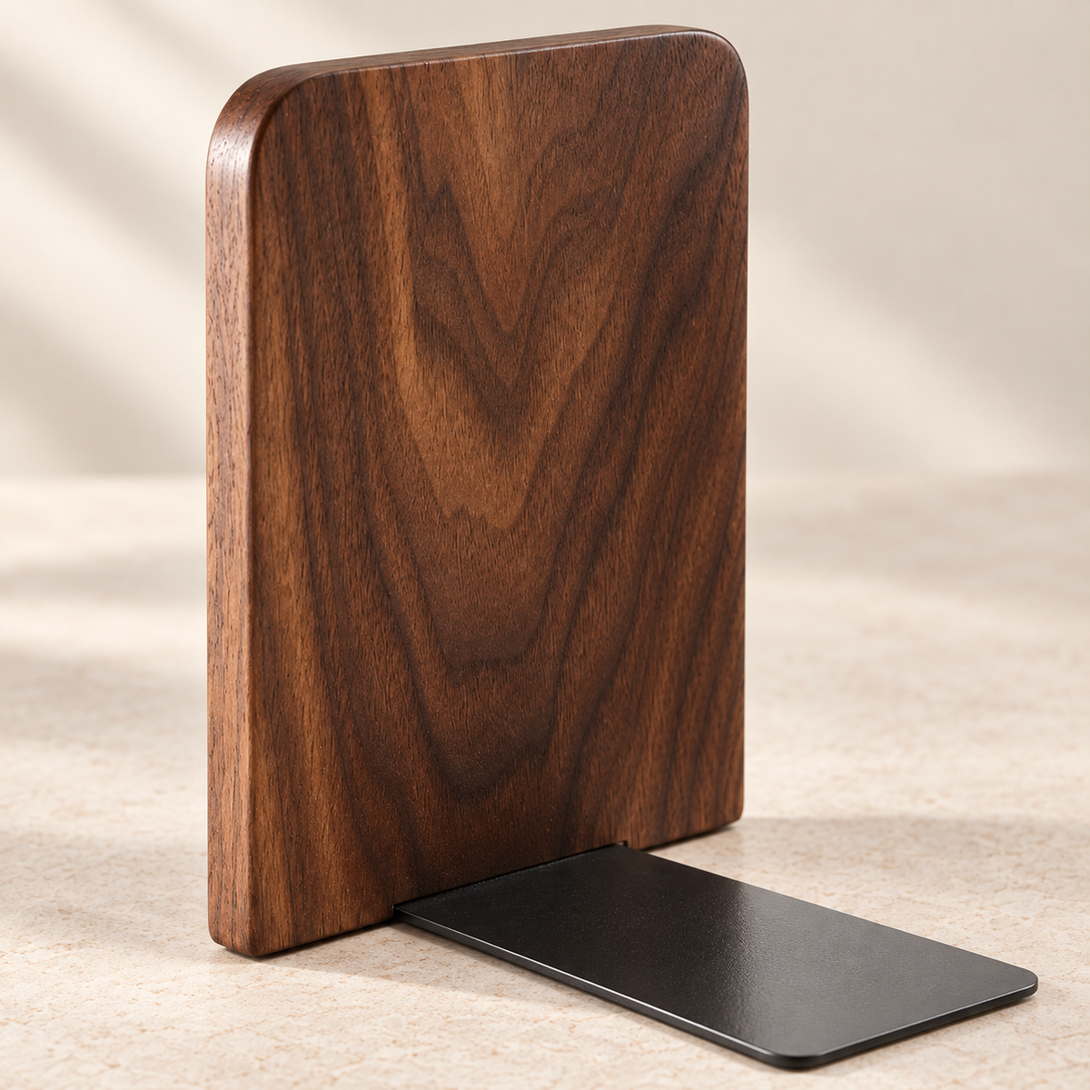 Close-up of solid walnut grain, rounded edge and matte black metal base