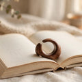 Walnut thumb page holder ring on open book